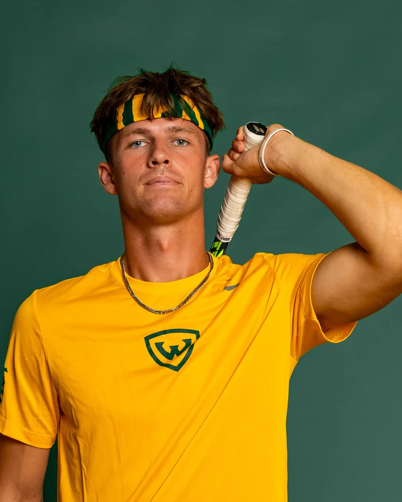 Cedric Drenth, 313 Tennis coach, in the gold Wayne State kit.